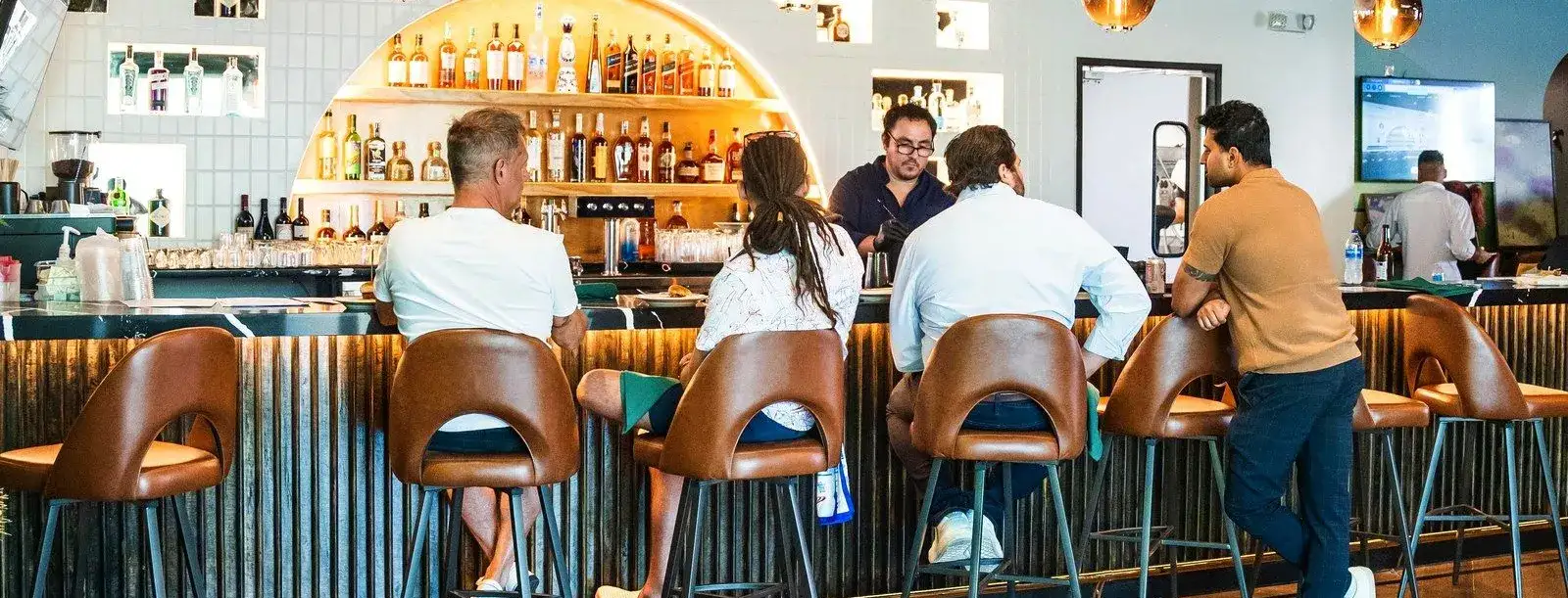 The dining room at Sip'Stroke Lounge looking across the banquettes toward the bar